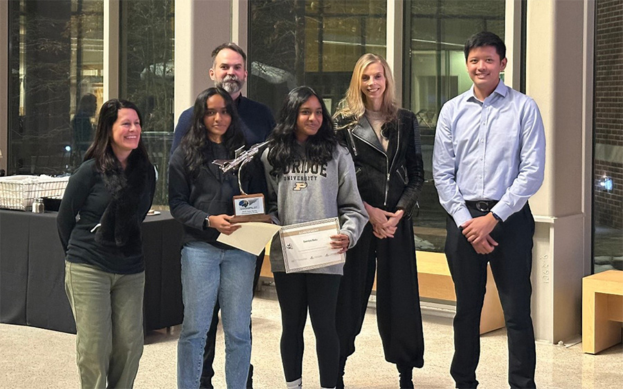 Group photo of the winning team with competition officials