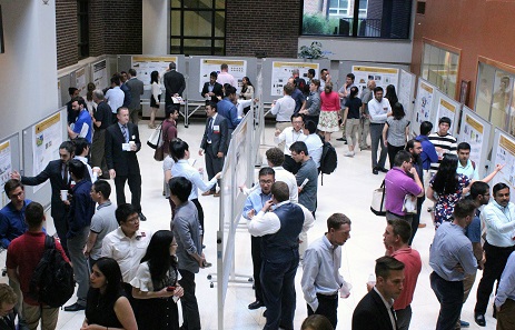 Symposium with many people and displays