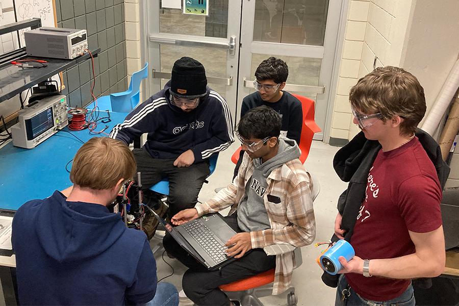 Members of the Purdue Space Programs Active Controls subteam calibrating sensors and debugging flight computer for the SysID test of the ASTRA flight vehicle.