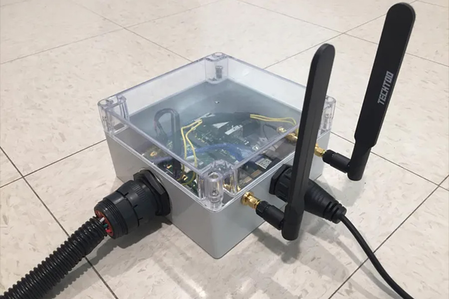 A small box featuring two antennas attached, designed for wireless communication or signal reception