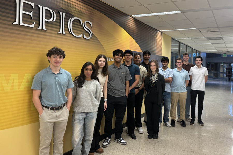 Group of students in a hallway in Armstrong Hall in front of an EPICS logo