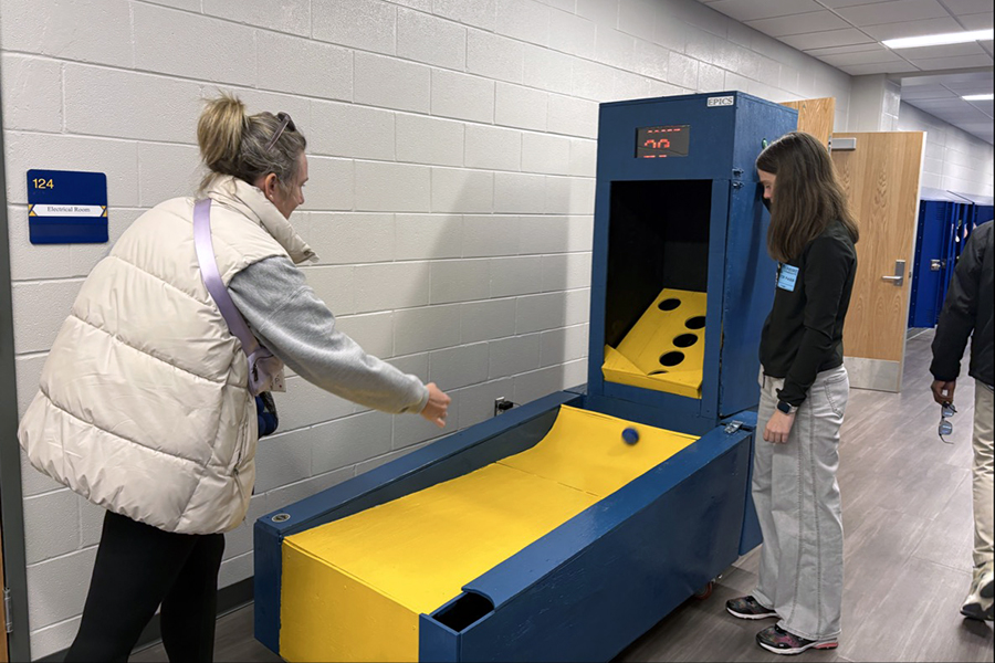 A woman playing skee ball