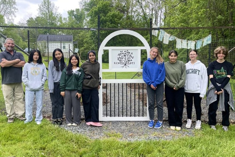 Group of students standing near gate