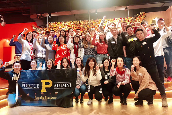 Students and Alumni with the Purdue Alumni flag
