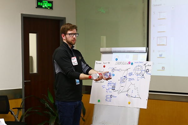 Student presenting with a white hand drawn diagram