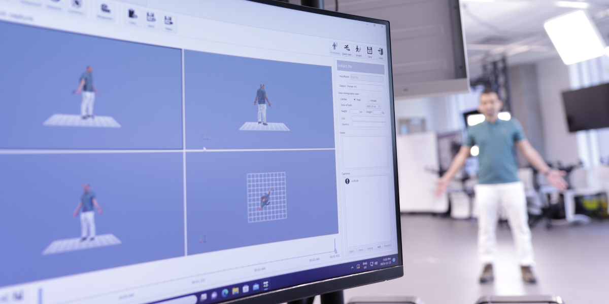 Graduate student demonstrating the Move4D equipment - Standing in "A Pose"