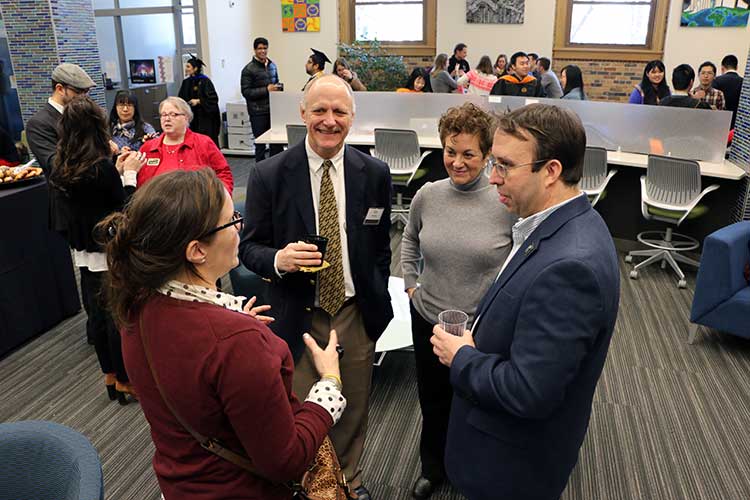 Prof. Bob Kenley and wife Barb chat with Master's graduate Christophe Cloitre and his wife