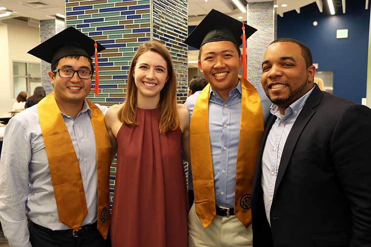 Prof. Brandon Pitts with 3 graduates