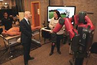 Photo of Maru Cabrera demonstrating Baxter robot