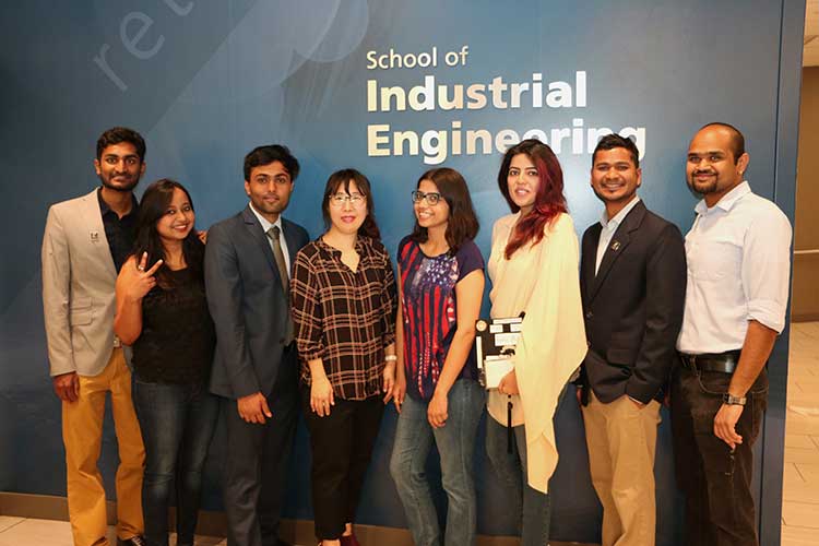 Graduate Program Specialist Anita Park (4th from left) with new Master's grads