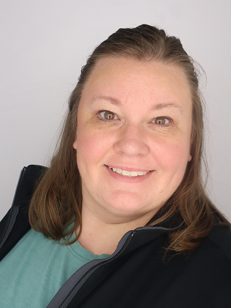 Head shot, woman with dark hair, brown eyes, smiling