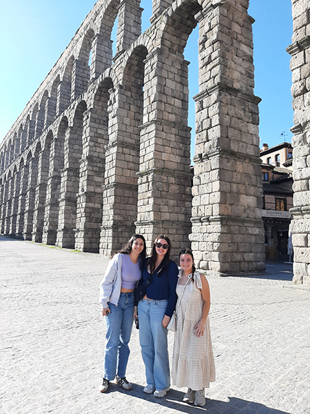 Students standing in front of ruins